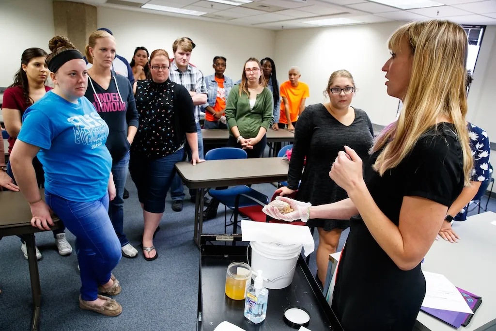 Professor talking to a group of students in a classroom.
