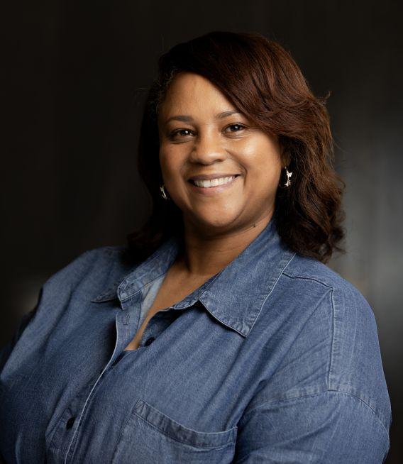 Professional photo of woman with denim shirt and medium-long hair. 